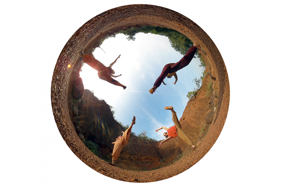 Dome shaped reflection image of four dancers outdoors