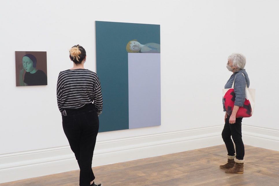 Two people looking at a painting in an exhibition | Richard Wathen, New Eyes Every Time / Llygaid newydd bob tro. MOSTYN, delwedd/image Lin Cummins