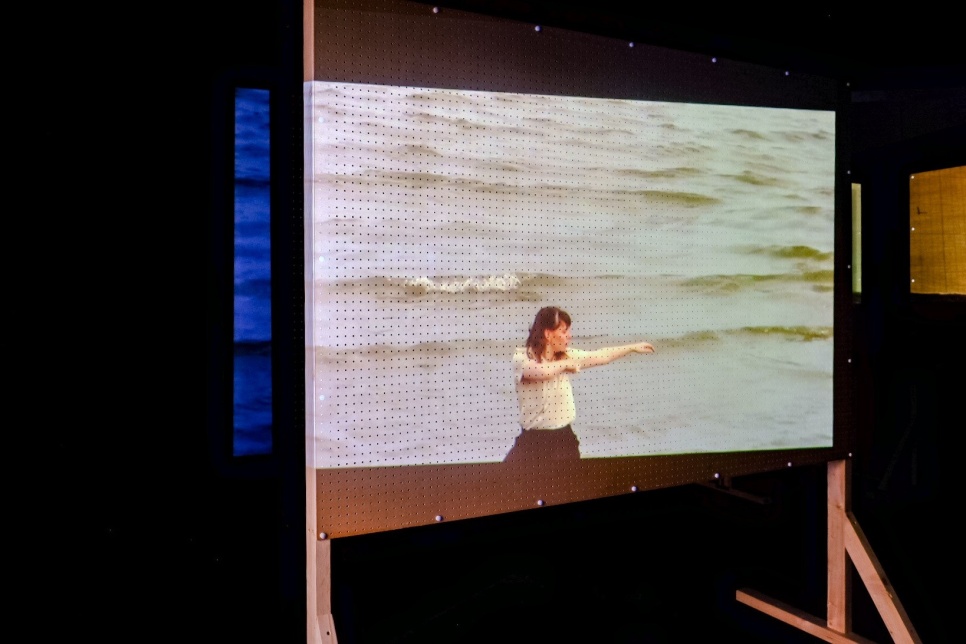 Image of a projector screen with woman dancing displayed