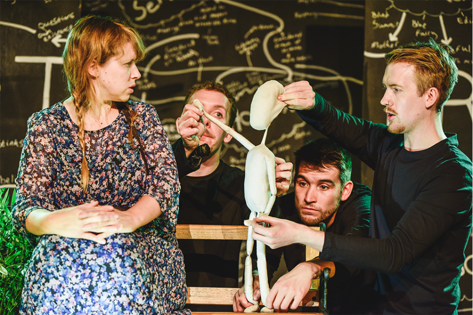 HIJINX_Meet Fred_Kirsten McTernan_2019 Four people acting onstage with a cloth puppet. Illustrations in the background