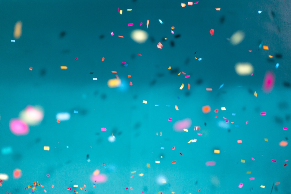 Blue background showing multicoloured confetti falling