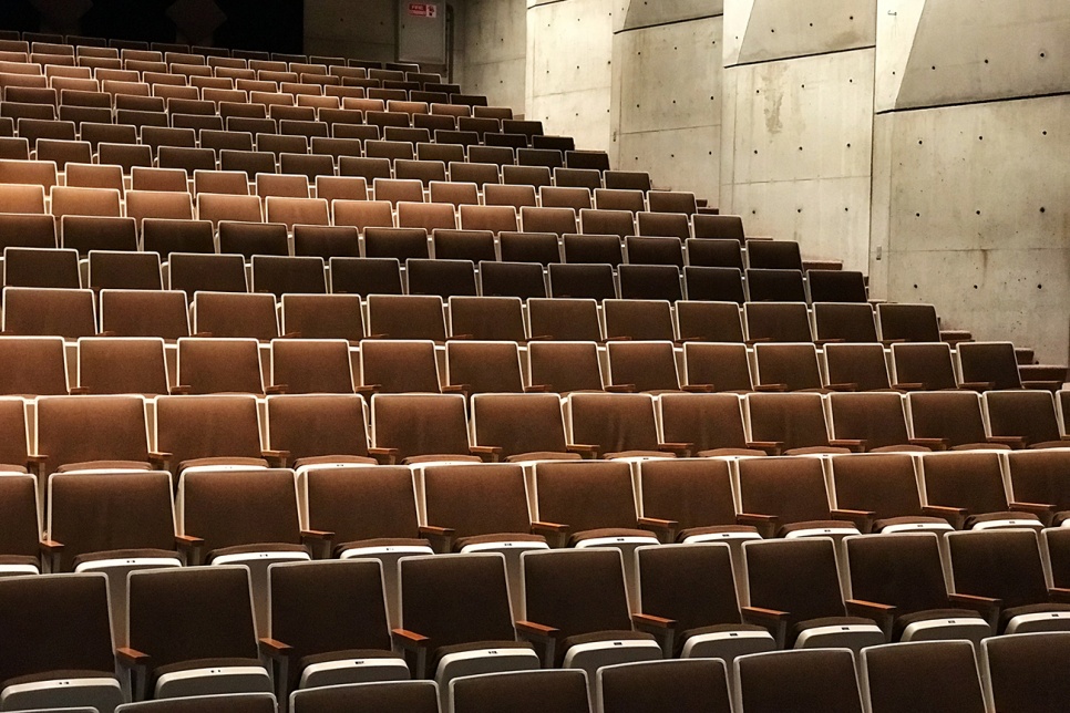 Rows of empty theatre chairs