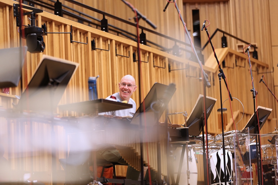 Person smiling in a recording studio