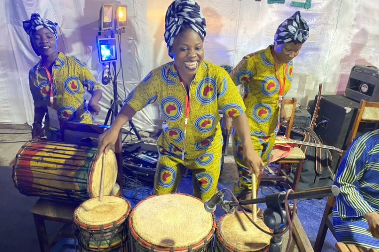 3 people playing traditional West African drums