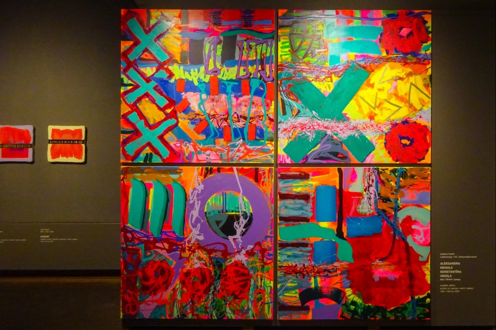 A large colourful art canvas displayed in a gallery