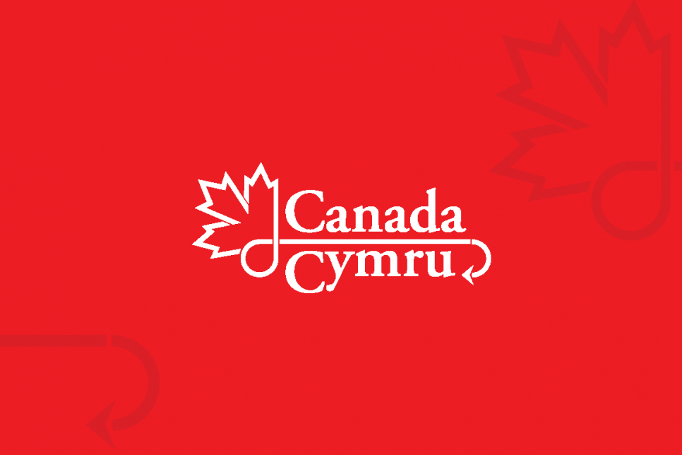 A red background with a maple leaf illustrated design in one corner and a text logo in the center that reads 'Canada Cymru' 