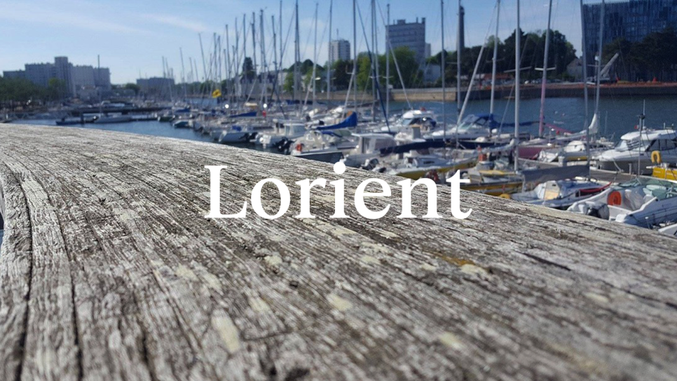 Decking and boats in the sunshine, with word 'Lorient' in white text
