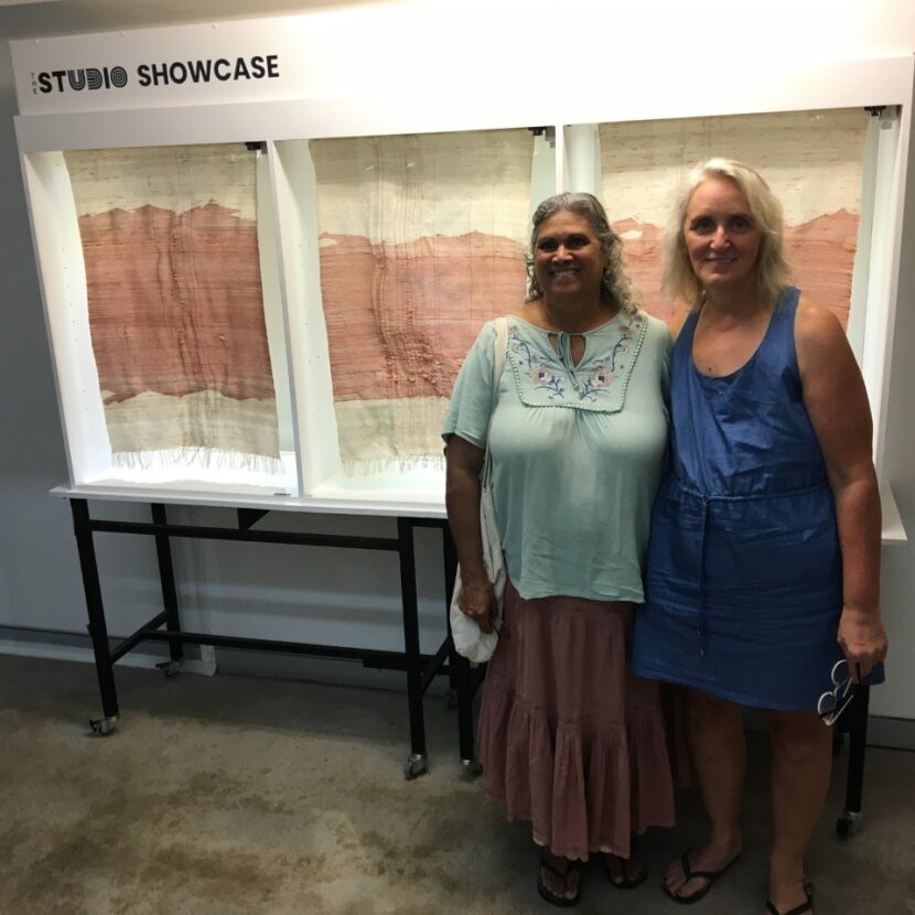 Susan and Veronica stood in front of artwork being desplayed