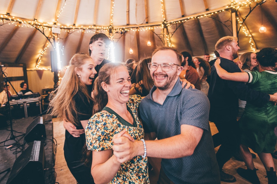 A man and woman dancing to folk music