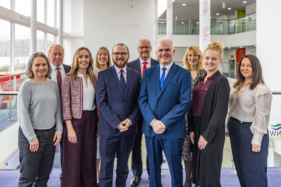 A group of people standing in the central atrium of Venue Cymru