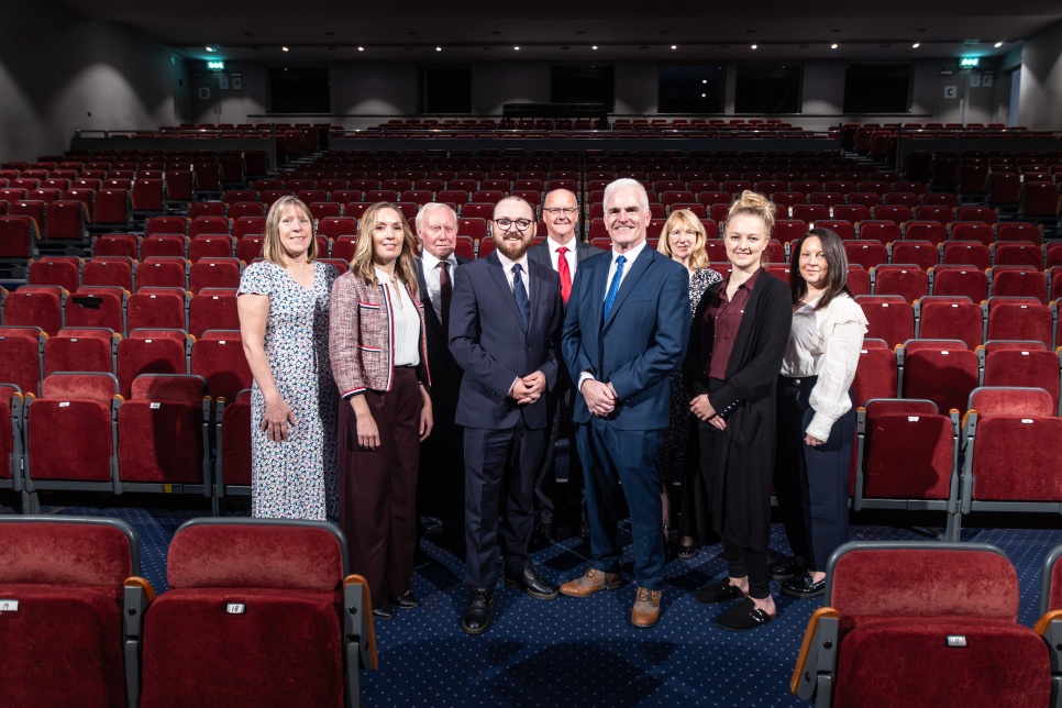 Group of people standing in a theatre auditorium