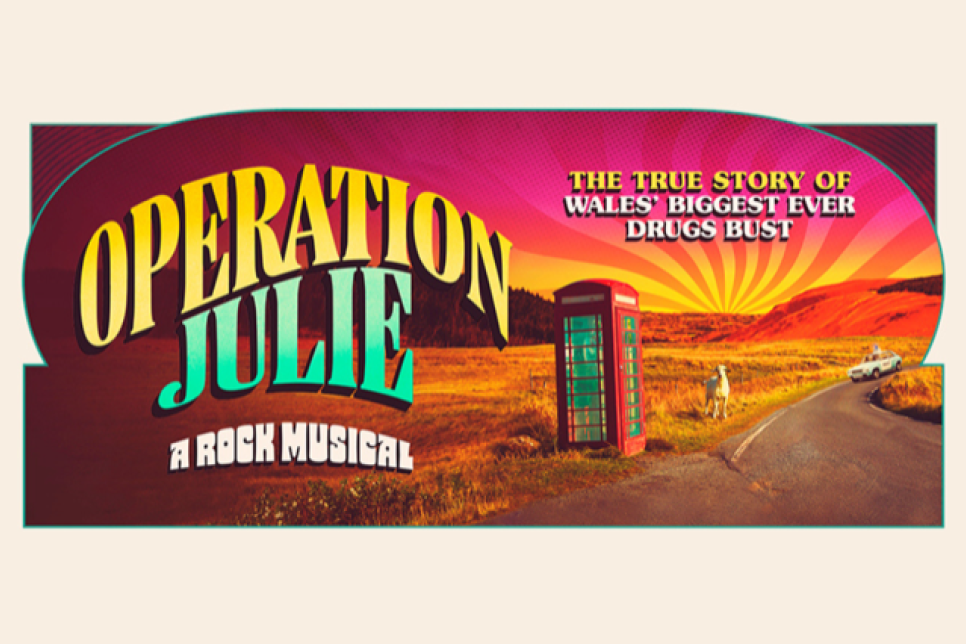 Operation Julie a New Musical. Picture shows a solitary red phonebox with a white goat and 1970s police car in the distance