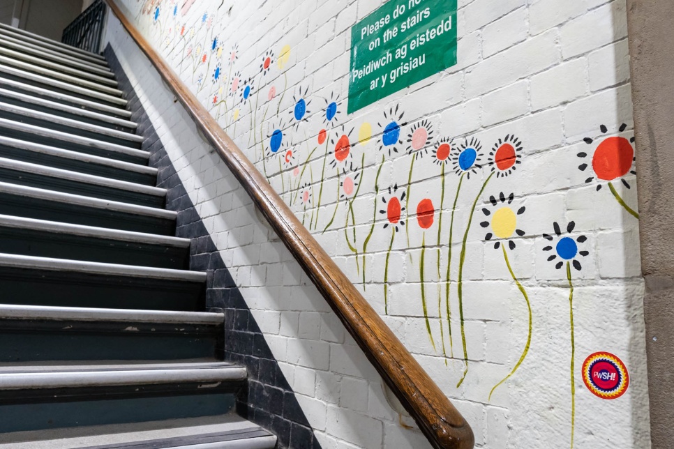 PWSH murals, flowers on the wall going up the stairs